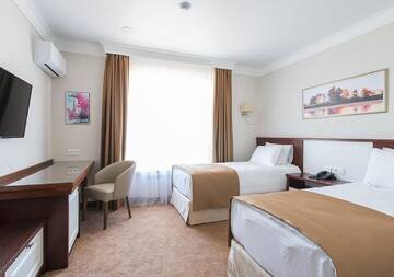 Фото номера Улучшенный двухместный номер с 2 отдельными кроватями Отель Boutique Hotel Kaspi г. Темиртау 3